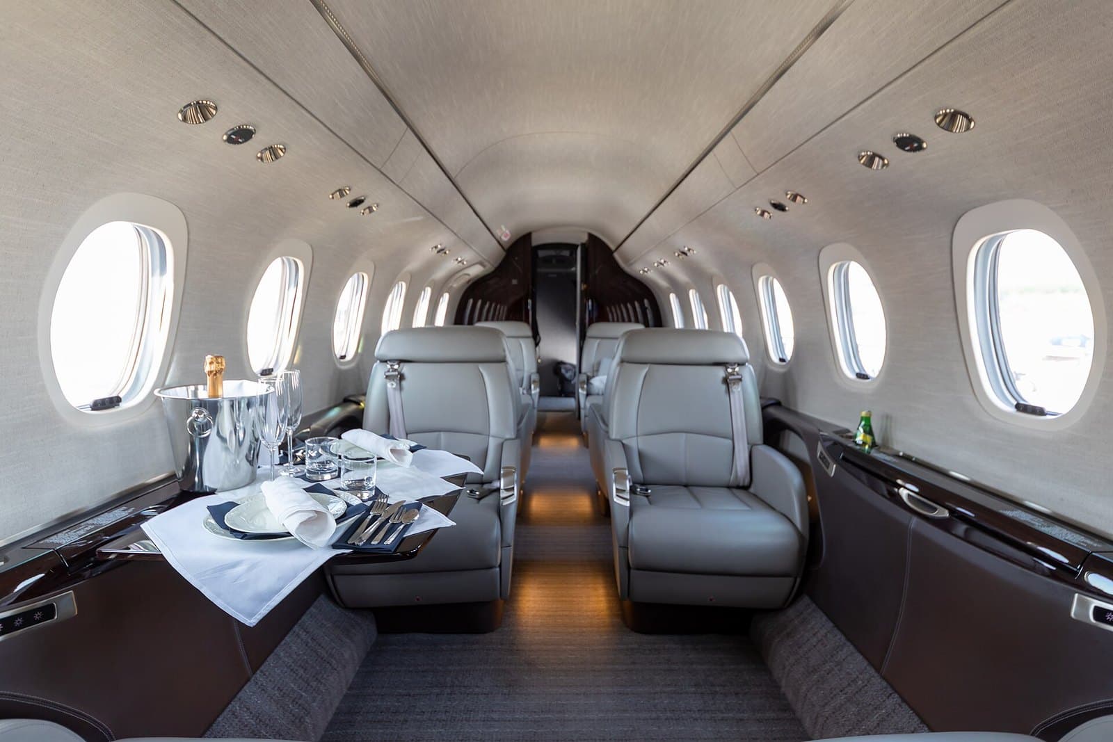 Cabin of a Cessna Citation Longitude with leather club seats and a set table