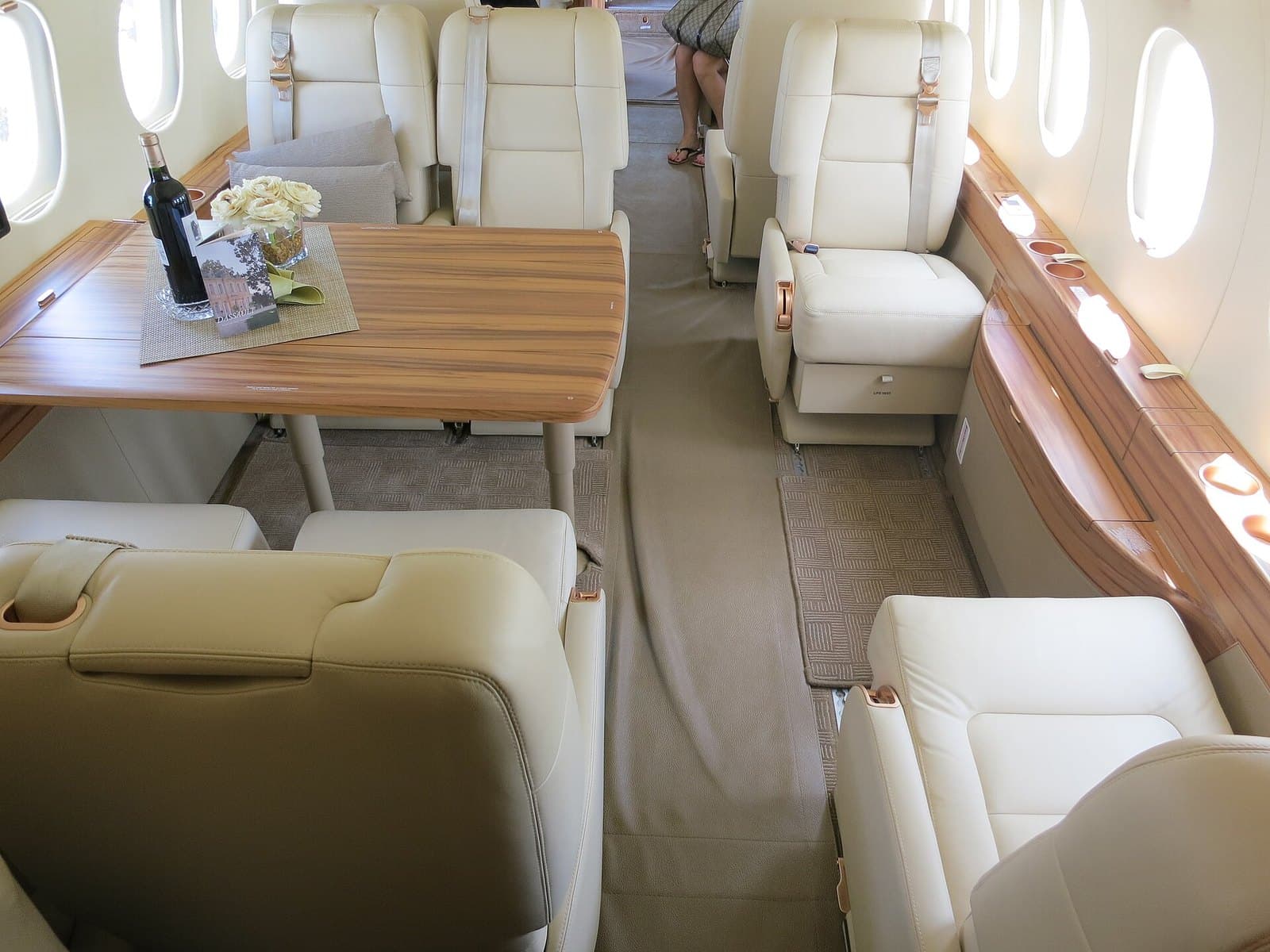 Cabin of a Dassault Falcon 2000LX with club seats and a dining table